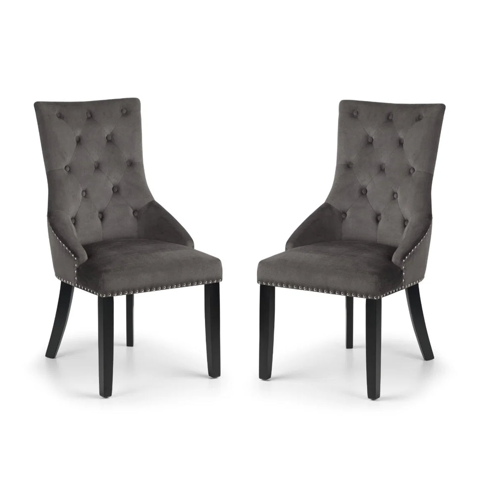 Two gray upholstered chairs with button tufting on a white background