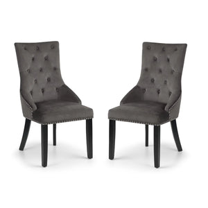 Two gray upholstered chairs with button tufting on a white background