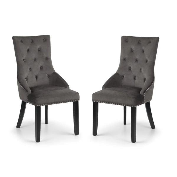 Two gray upholstered chairs with button tufting on a white background
