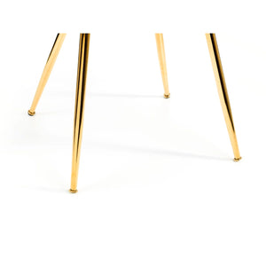 CLOSE UP OF A MONZA DINING CHAIR - GOLD METAL LEGS