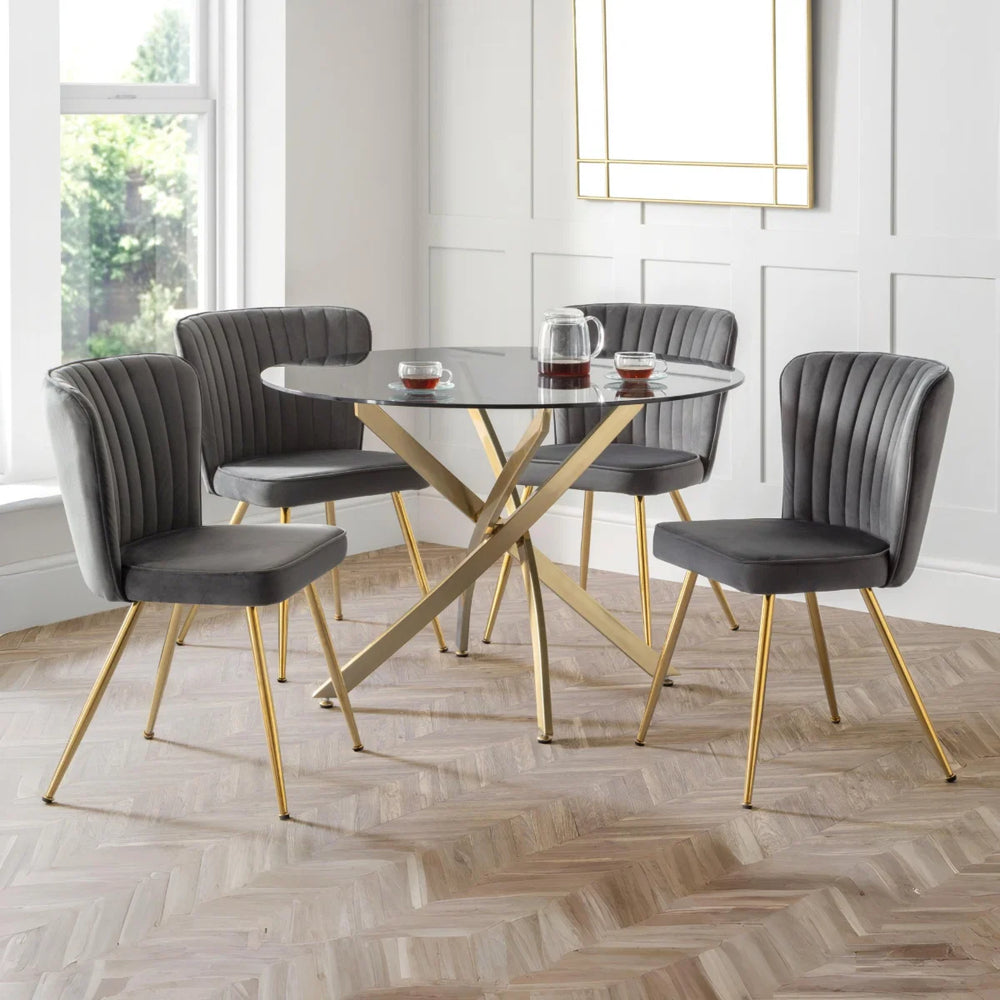 2 GREY DINING CHAIRS WITH GOLD METAL LEGS ON A WHITE BACKGROUND