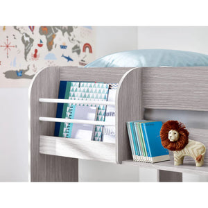 Children's room with a bed, bookshelf, and decorative items.