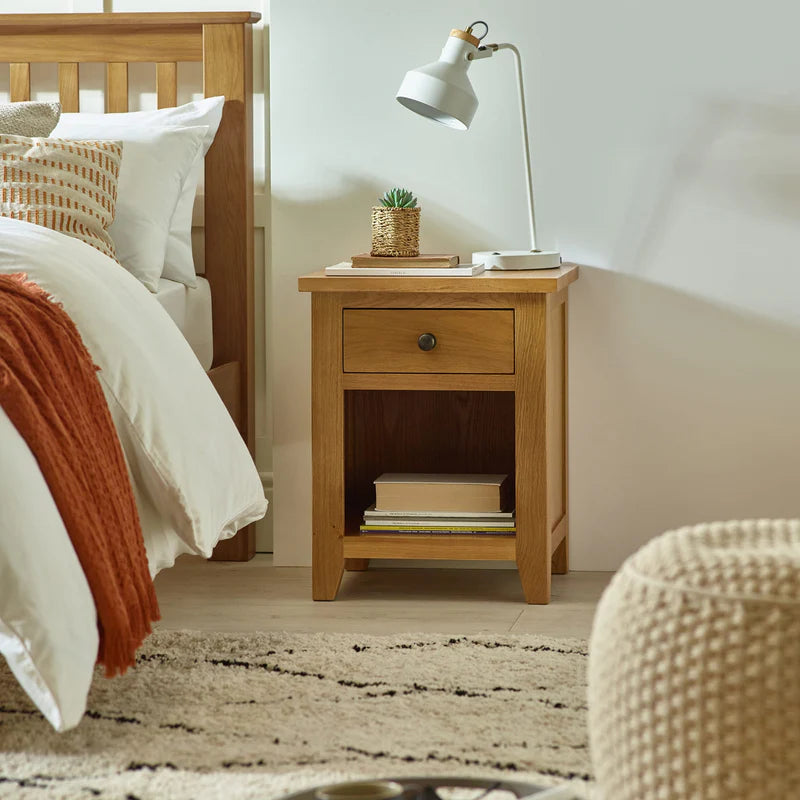 Wooden side table with a drawer on a white background