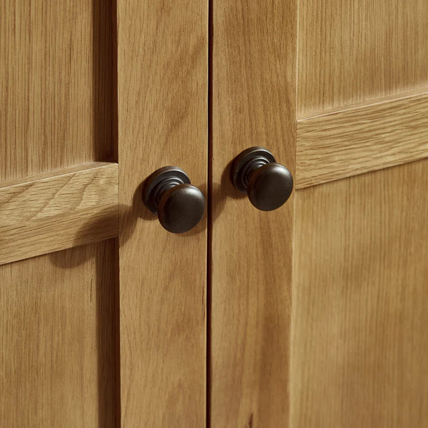Close-up of wooden cabinet doors with black knobs