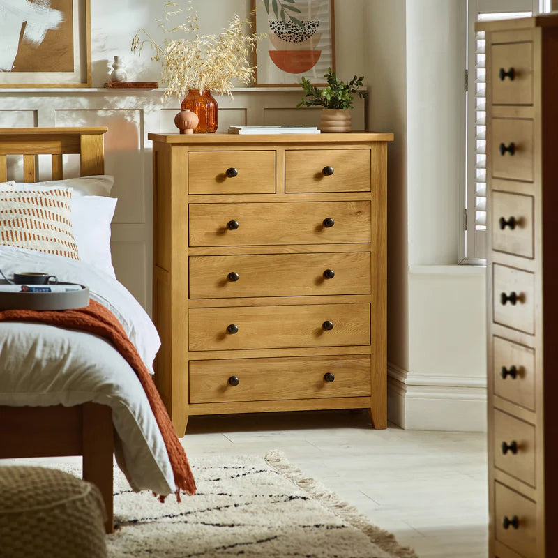 Wooden dresser with five drawers on a white background