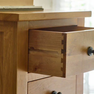Wooden drawer of a piece of furniture with a visible joinery detail.