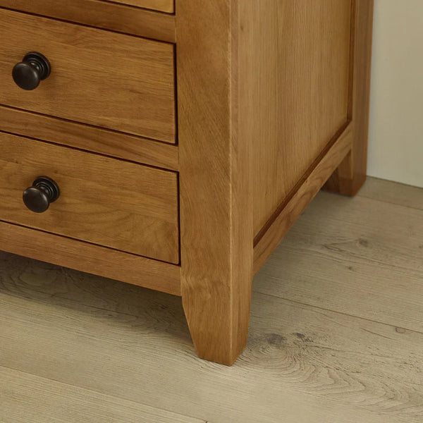 Wooden dresser with two drawers on a wooden floor.