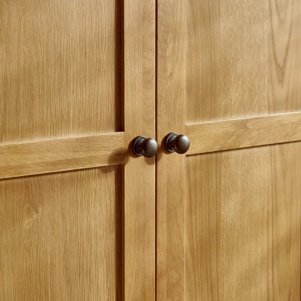 Close-up of wooden cabinet doors with dark handles