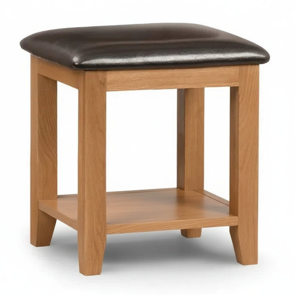 Wooden stool with a brown leather seat on a white background