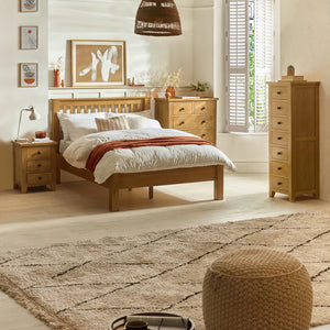 Bedroom with wooden furniture including a bed, nightstands, and a dresser.
