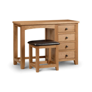 Wooden desk with three drawers and a matching stool on a white background