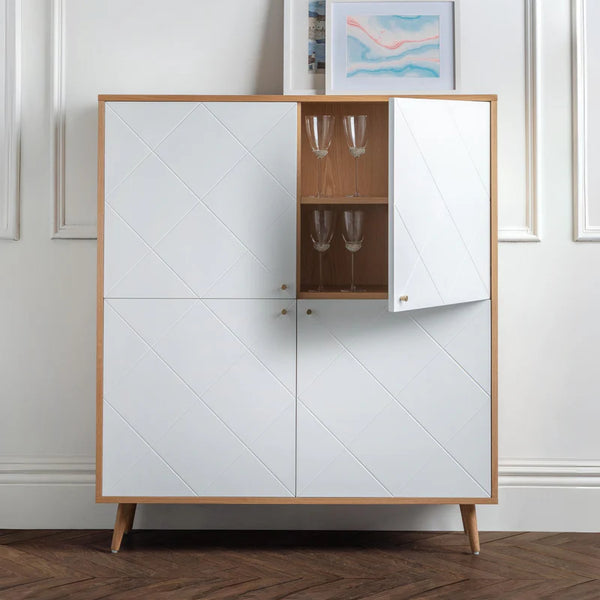White cabinet with wooden frame and glass shelves against a white wall.