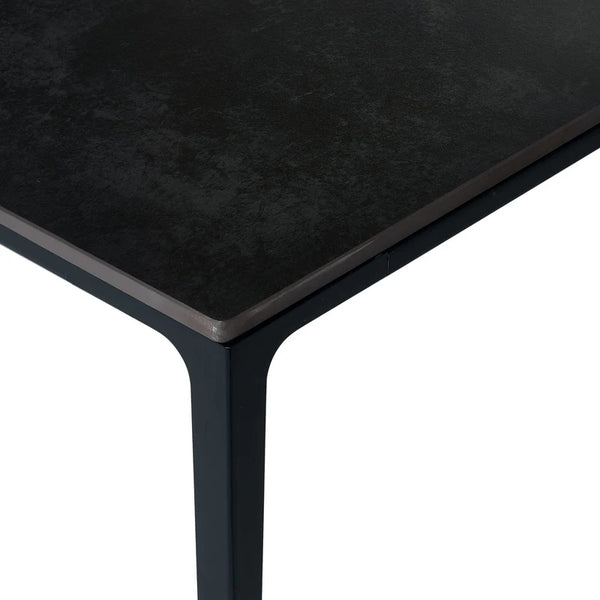 Black rectangular table with a textured surface on a white background
