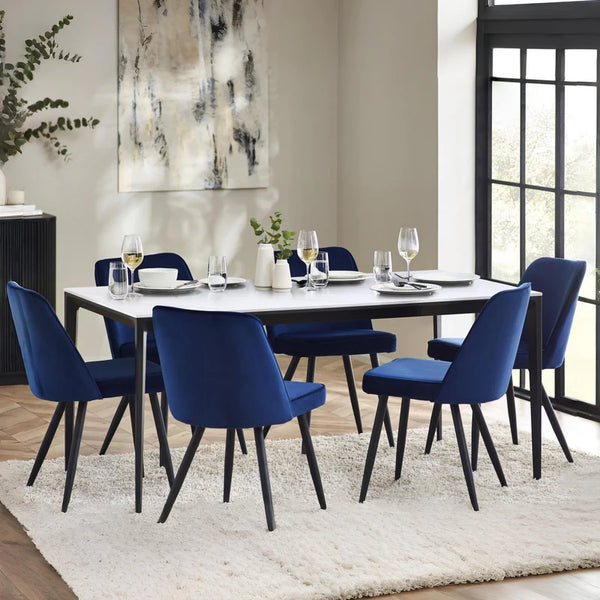 Dining room with a table and blue chairs in a modern interior setting.