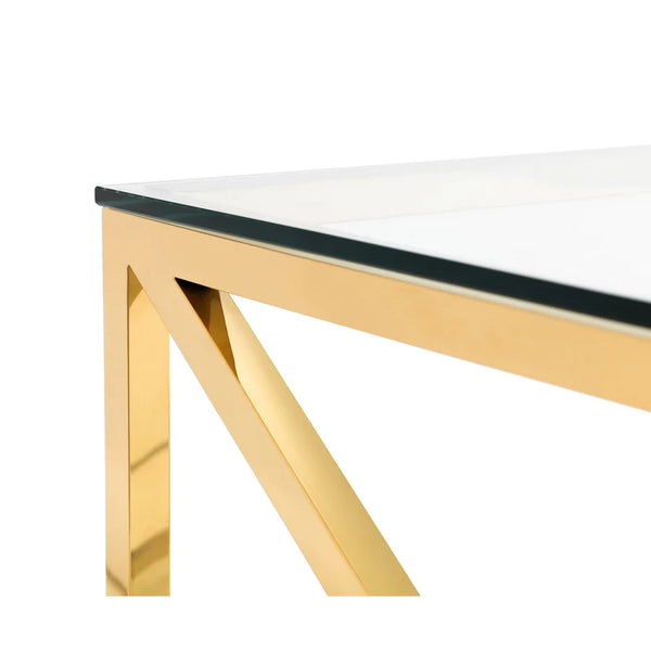 Glass table with gold metal legs on a white background