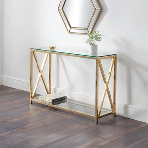 Gold console table with glass top in a room setting