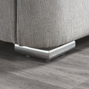 Close-up of a textured gray bed with metallic leg on a wooden floor.