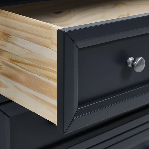 Close-up of a black drawer with a wooden surface and metal handle.