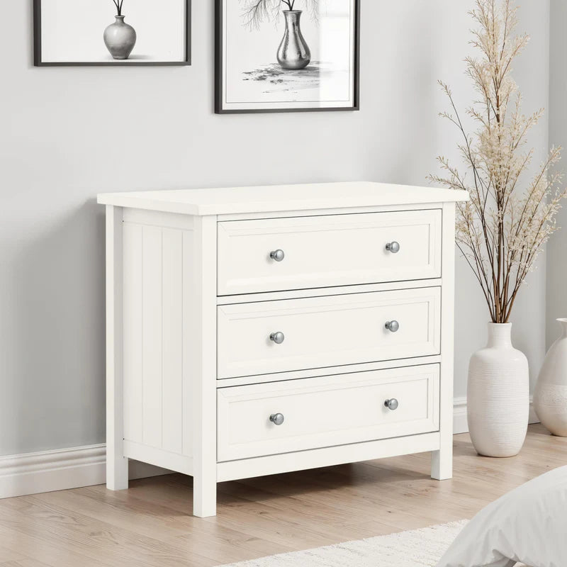 White dresser with three drawers on a white background