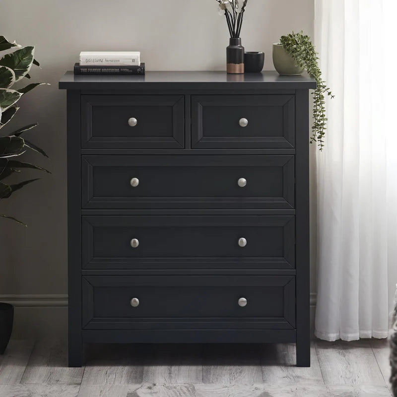 Black dresser with silver knobs on a white background