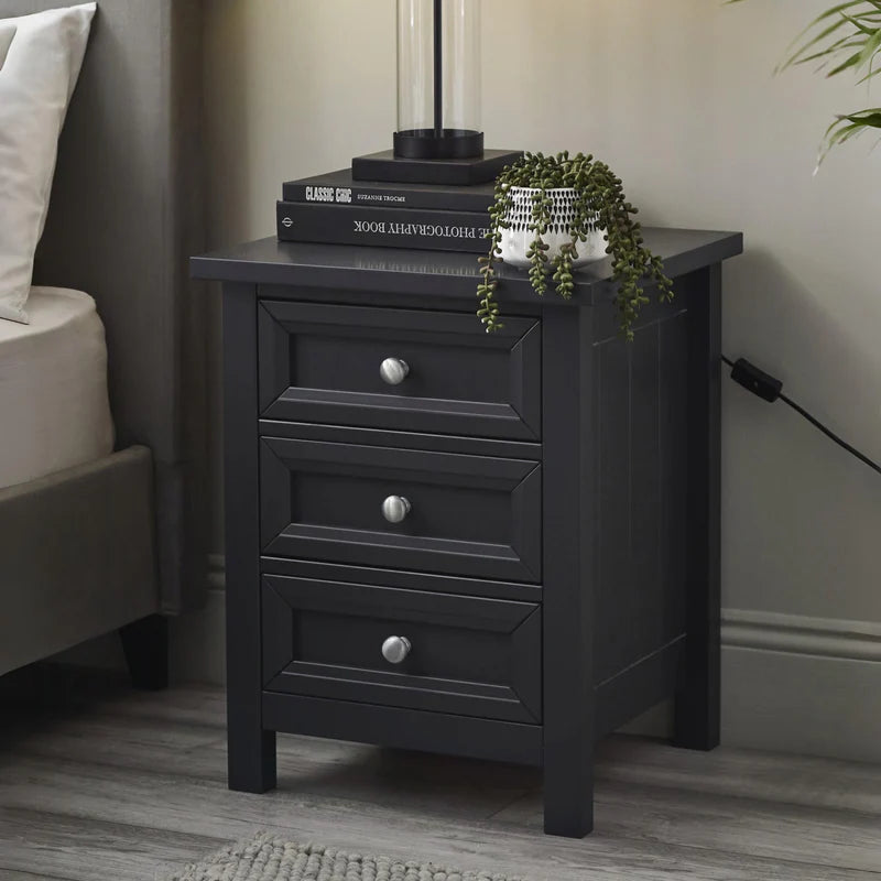 Dark gray nightstand with three drawers on a white background