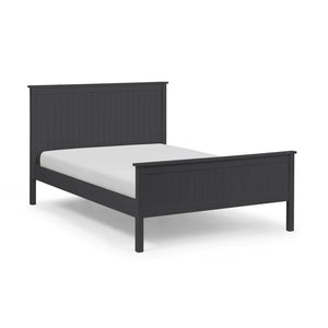 Black bed frame with white mattress on a light gray background