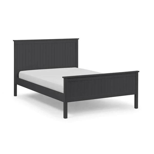 Black bed frame with white mattress on a light gray background