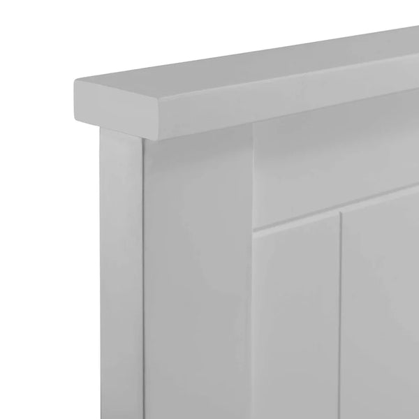 Close-up of a light gray wooden cabinet corner on a white background