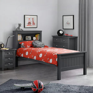 Children's bedroom with gray bed frame, red bedding, and sports-themed decor.