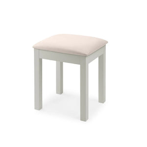 Small stool with a beige cushion on a white background