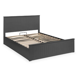 Wooden bed with plaid bedding and pillows on a white background