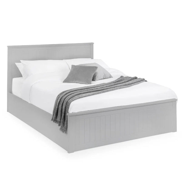 Gray bed with white bedding and gray blanket on a white background