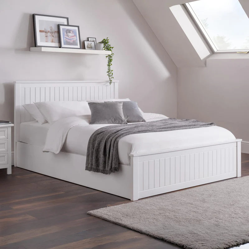 White bed with gray bedding on a white background