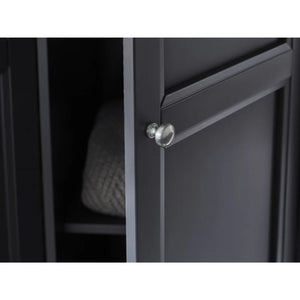 Close-up of a black cabinet with a silver knob on a white background