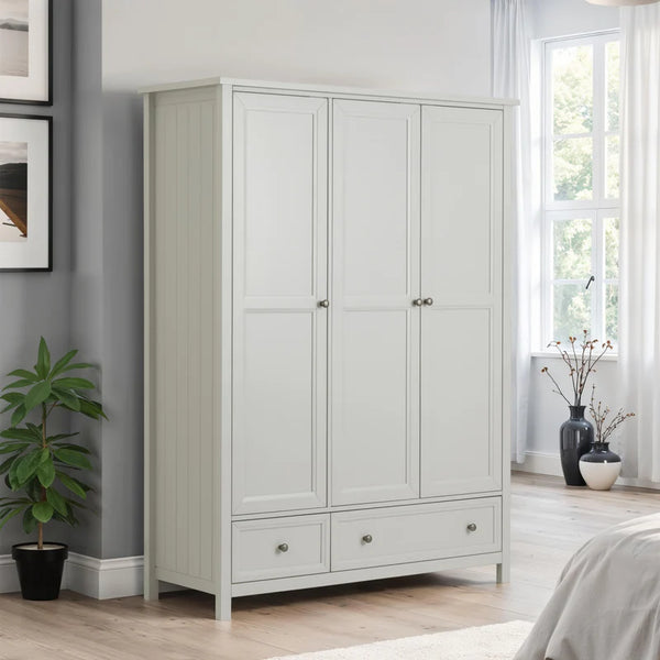 Gray wardrobe in a bedroom with a plant and window in the background