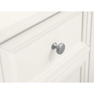 Close-up of a white cabinet with a silver knob on a white background