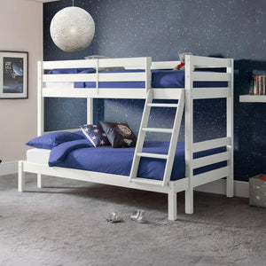 White bunk bed with blue bedding in a room with a starry wall.