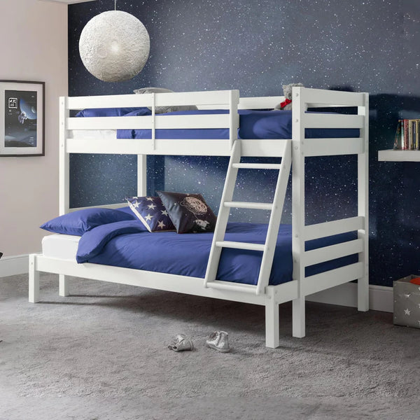 White bunk bed with blue bedding in a room with a starry wall.