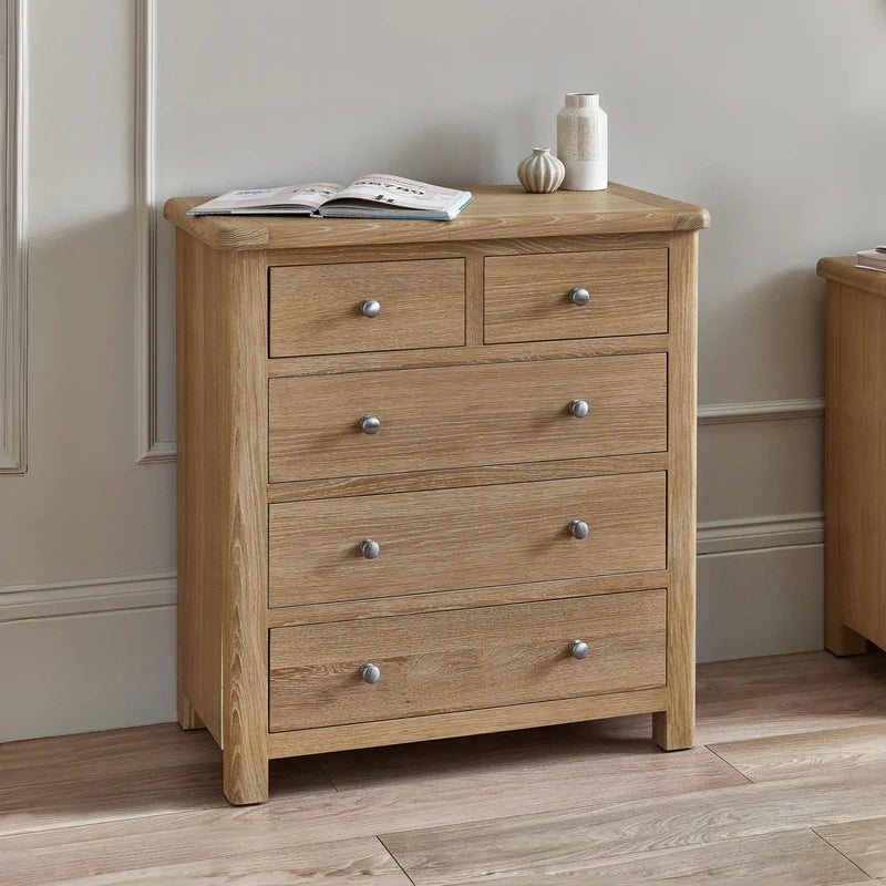 Wooden dresser with six drawers and metallic handles on a white background