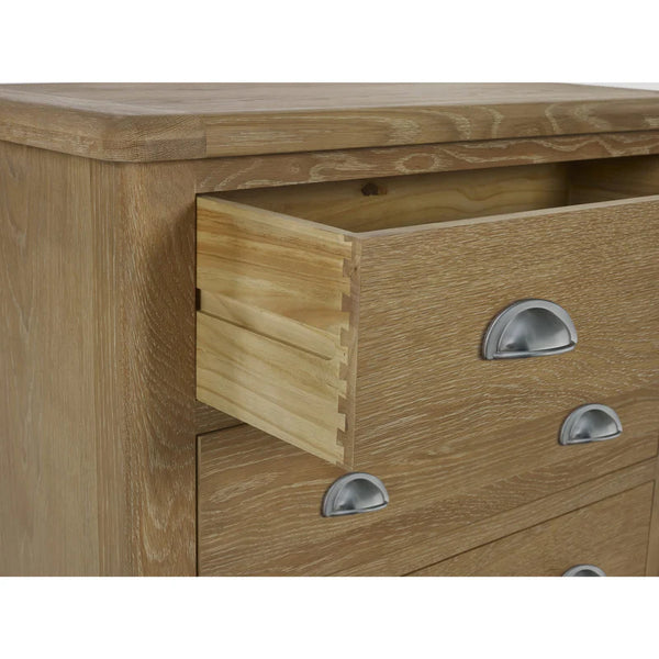 Wooden drawer unit with three drawers and metallic handles on a white background
