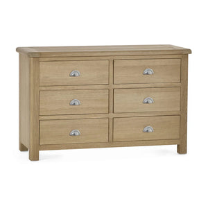 Wooden dresser with six drawers on a white background