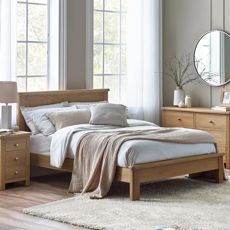 Wooden bed frame with a white mattress on a white background