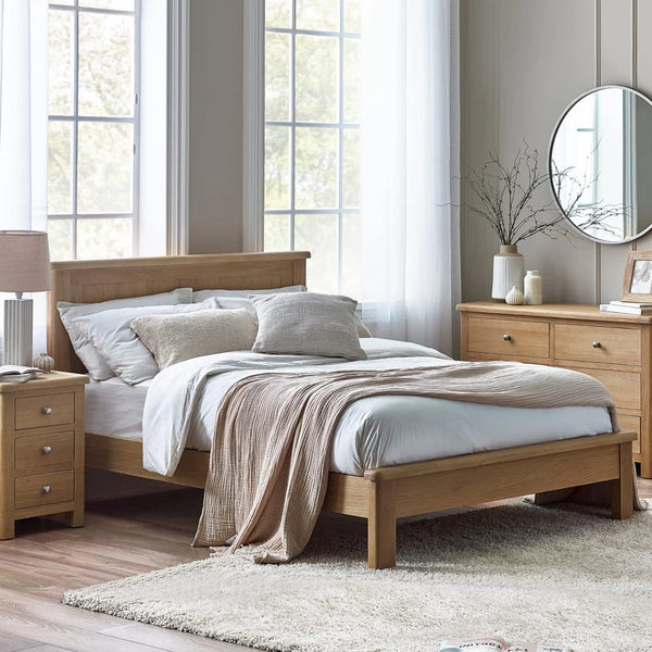 Wooden bed in a bedroom with light decor