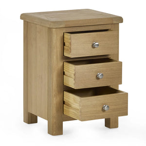Wooden nightstand with three drawers on a white background