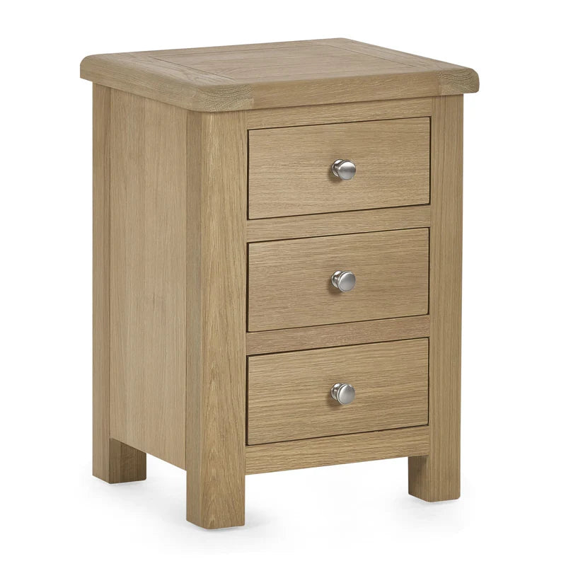 Wooden nightstand with three drawers and silver knobs on a white background