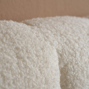 Close-up of a textured white fabric against a brown background