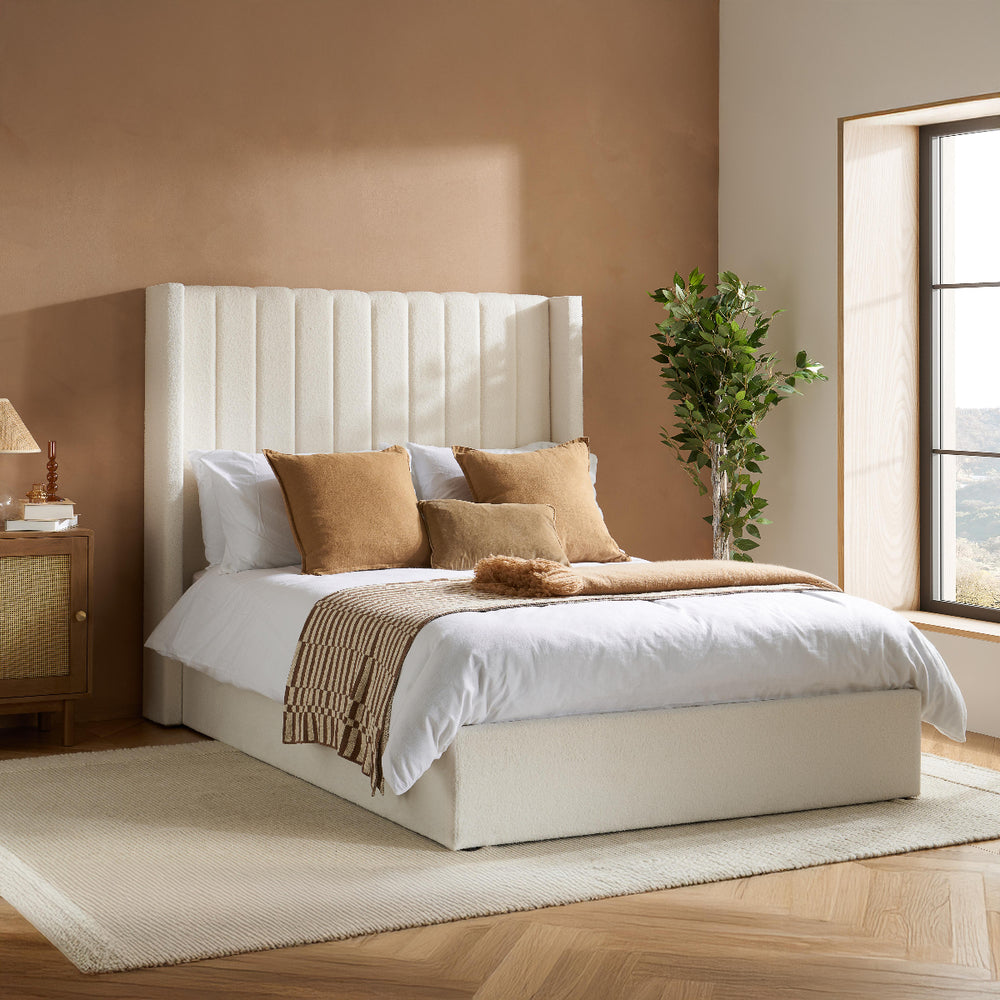 White bed frame with open storage compartment on a white background