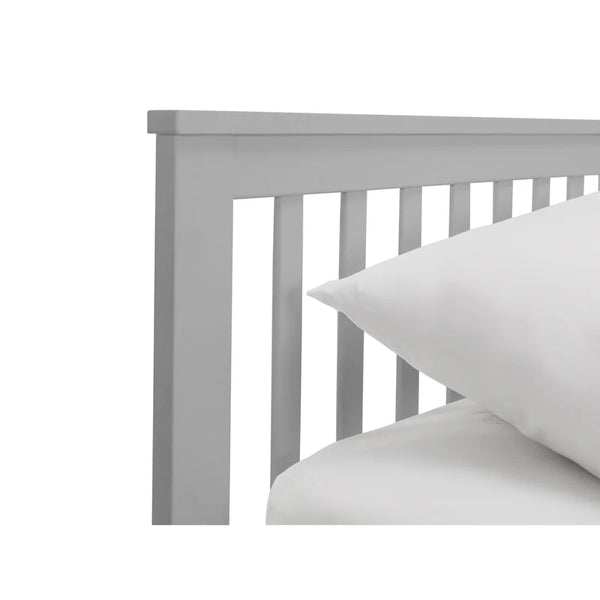 Gray wooden headboard with white pillows on a white background