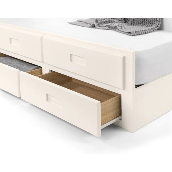 White bed with open wooden drawers on a white background