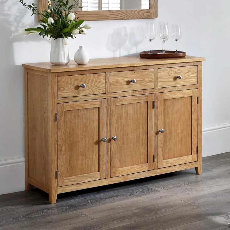Wooden sideboard with three doors and two drawers on a white background